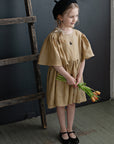 a little girl holding a bunch of flowers