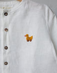 A white button-down shirt with a small embroidered duck on the front.