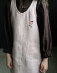 a little girl wearing a dress with a flower on it
