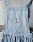 Baby Blue Cross Back Linen Pinafore, Flying pig (blue) embroidery, Size 5-6 years